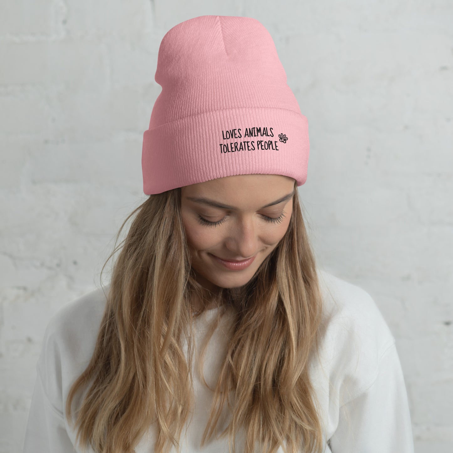 Girl with pink cuffed beanie with black loves animals tolerates people embroidery