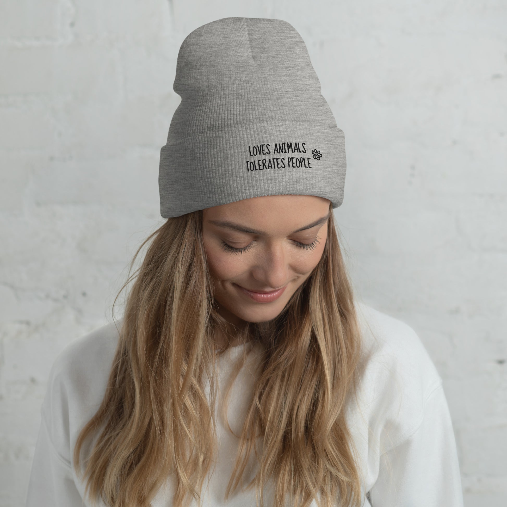 Girl with grey cuffed beanie with black loves animals tolerates people embroidery