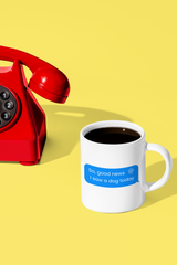 Message bubble that says good news I saw a dog today printed on a white mug near a red vintage telephone